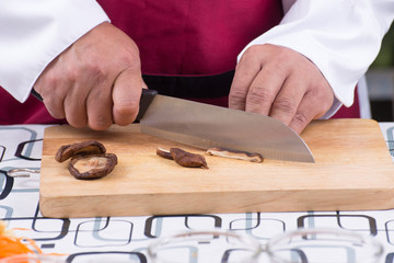 Chef cutting mushroom
