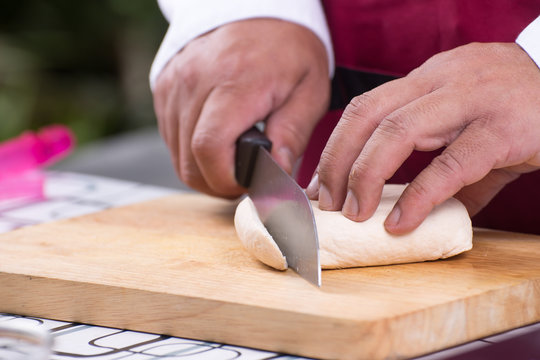 Chef slicing tofu for cooking
