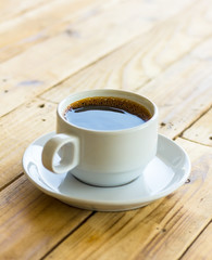 Coffee cup on wooden table background