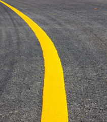 road Asphalt surface of the road with a yellow line.
