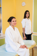 Obraz premium Woman beautician doctor with patient in spa wellness center. Young female professional cosmetologist make neck massage to beautiful brunette girl in cosmetology cabinet or beauty parlor.