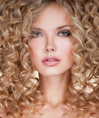 Beautiful blonde woman. Healthy Long Blond Hair. Curly Hair.   B