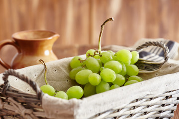 grapes in a basket on an old wooden table