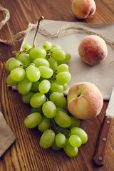 grapes and peaches on an old wooden table