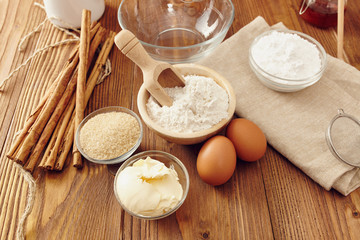 Ingredients to make a cake or a dessert on an aged wooden table
