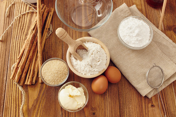 Ingredients to make a cake or a dessert on an aged wooden table