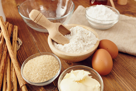 Ingredients to make a cake or a dessert on an aged wooden table
