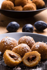 plum dumplings on black plate