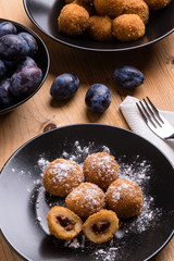 plum dumplings on black plate