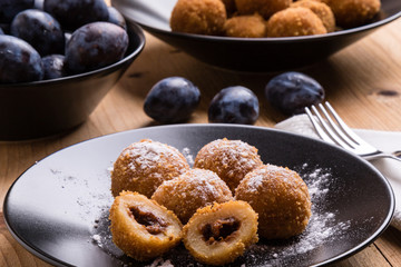 plum dumplings on black plate