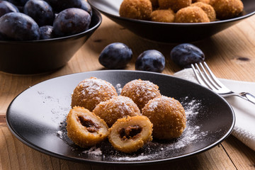 plum dumplings on black plate