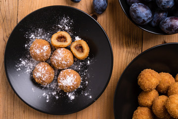 plum dumplings on black plate