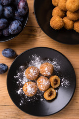 plum dumplings on black plate