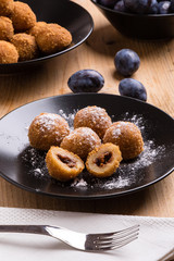 plum dumplings on black plate