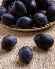 fresh healthy plums on table