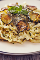 handmade fettuccine pasta with pesto genovese sauce and fried courgette