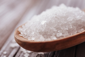 Fototapeta na wymiar Salt crystals in a wooden spoon