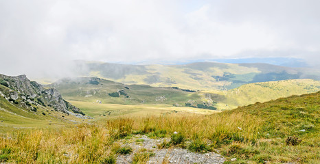 Transalpina road, Parang Mountains, hills with green grass and rocks