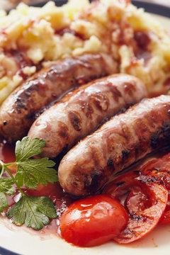 Sausage and mush dish with grilled mushrooms and tomatoes