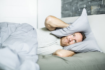 Obraz na płótnie Canvas Tired man in the bed