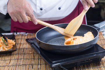 Chef cooking Pad Thai wraped wuth egg