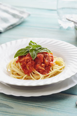 spaghetti amatriciana on a blue wooden table (Italian dish)