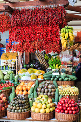 Fresh exotic fruits and red chili pepper on famous market in Funchal (Mercado dos Lavradores), Madeira island, Portugal