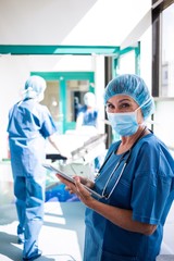 Surgeon using digital tablet in corridor