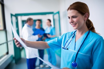 Smiling surgeon examining a report