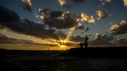 Lighthouse and ocean sunset