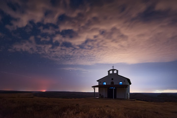 Starry cloudy night over the Chapel of St. George, Rusokastro village, Bulgaria 