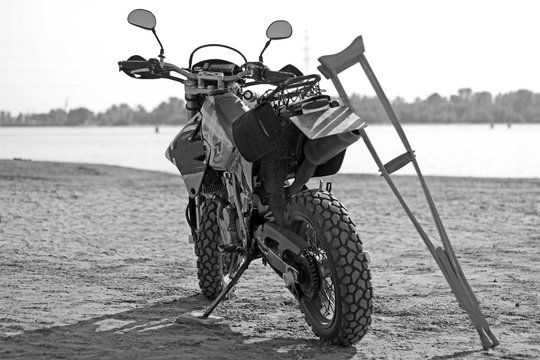 Motorcycle and crutches in black and white tone. Blurred backgrund