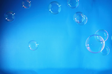 Rainbow soap bubbles on a blue backgrounds