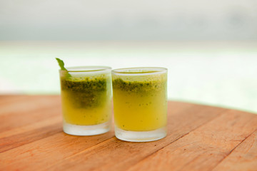 glasses of fresh juice or cocktail on beach
