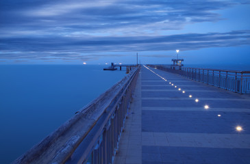 Obraz premium Before sunrise in Burgas bay. Bridge in Burgas, Bulgaria. Long exposure, blue hour. Kay port