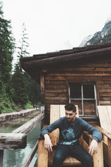 Man sit on a wood chair at braies lake - 121566573