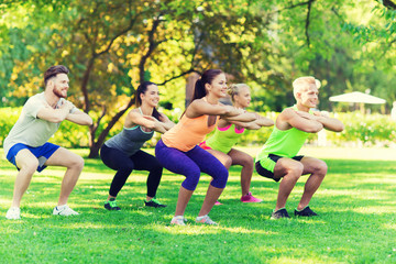 group of friends or sportsmen exercising outdoors