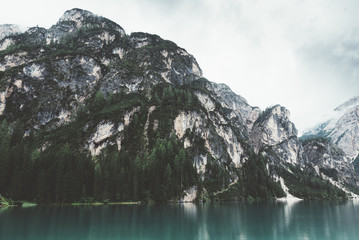 Lake Braies with blue water, mountains and trees - 121566775
