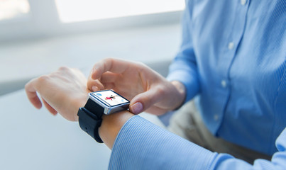 close up of hands with fitness app on smart watch