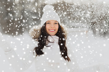 happy woman with snow outdoors in winter