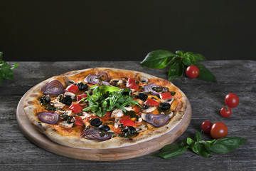 Pizza with onions , black olives , peppers , mushrooms on the wo