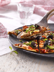 Pizza slice in sunlight with props.