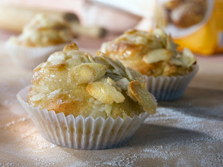 Tosca bun. Muffin tin. Mealy wood background.