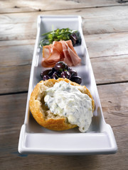 Tzazziki and other appetizers. Gray old wood background.