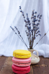 Obraz na płótnie Canvas French macaroons and lavender on wooden table.