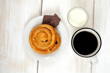 Simple Breakfast: bun roll with raisins, chocolate and coffee mi