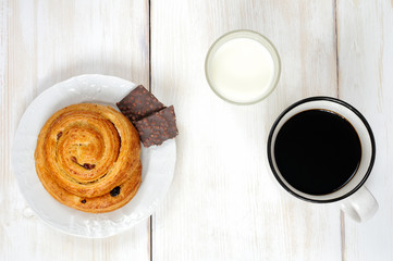 Simple Breakfast: bun roll with raisins, chocolate and coffee mi