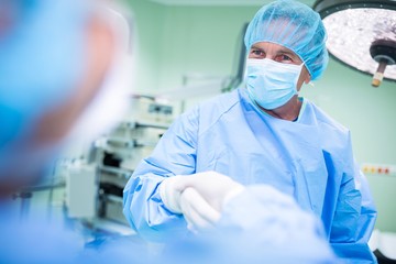 Surgeons shaking hands in operation room
