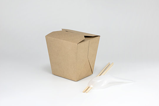 Brown paper cardboard food container with chopsticks and plastic spoon