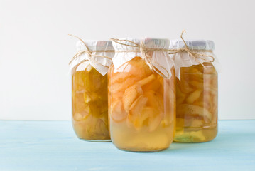 Jam of pears and apples in glass jars on a blue wooden background